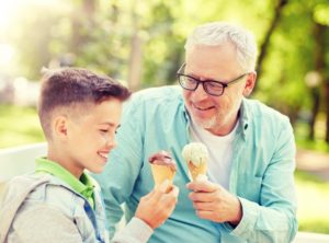 grandpa eating ice cream with grandson 