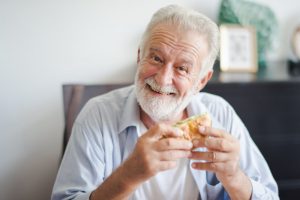 happy old man eating burger