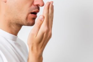 man checking his own breath