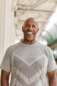mature man outside with confident smile 
