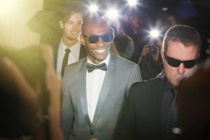 young man smiling on red carpet 