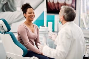 young woman talking to dentist in Massapequa Park