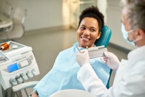 woman being shown a selection of veneers