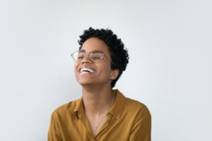woman with glasses smiling 