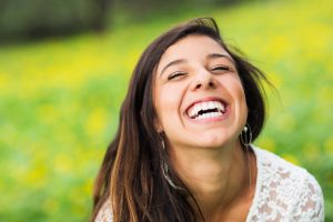 portrait of a woman laughing outdoors