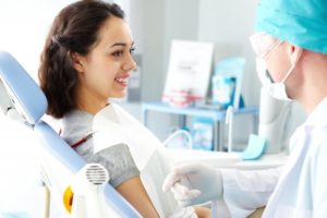 young woman smiling at cosmetic dentist