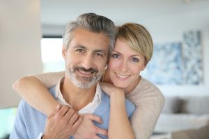 smiling middle-aged couple in home