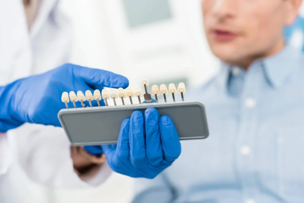 Doctor Explaining Emergency Dental Implants Long Island to Male Patient