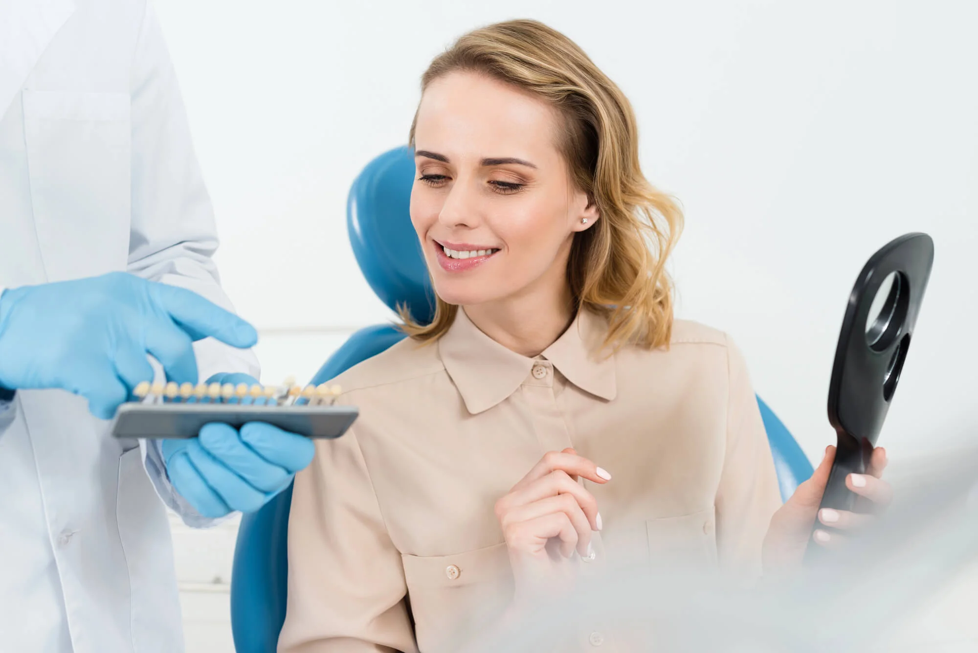 Doctor Showing Emergency Dental Implants Long Island Options to Female Patient