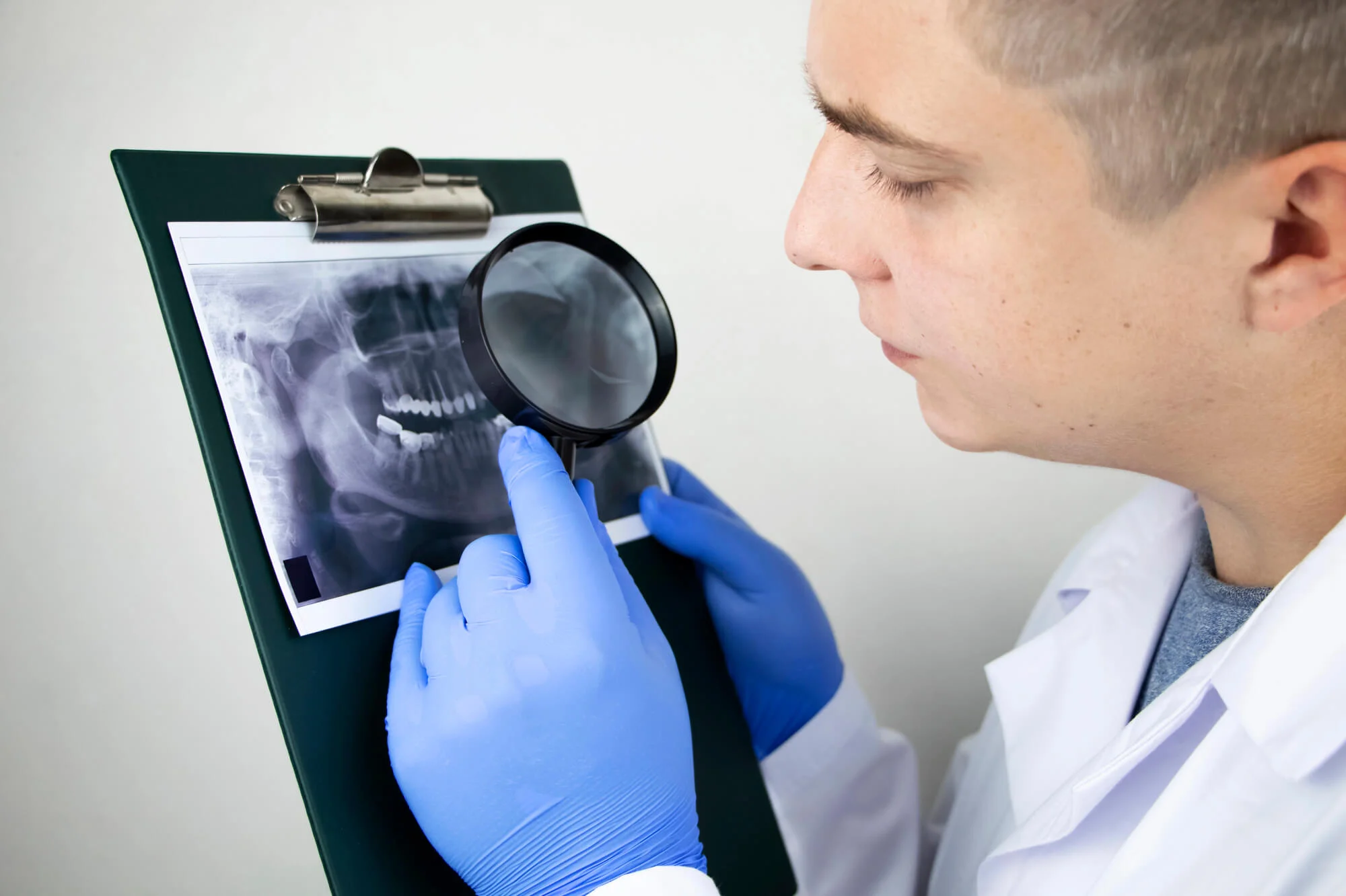 Long-Island-dentist-analyzing-a-dental-X-ray