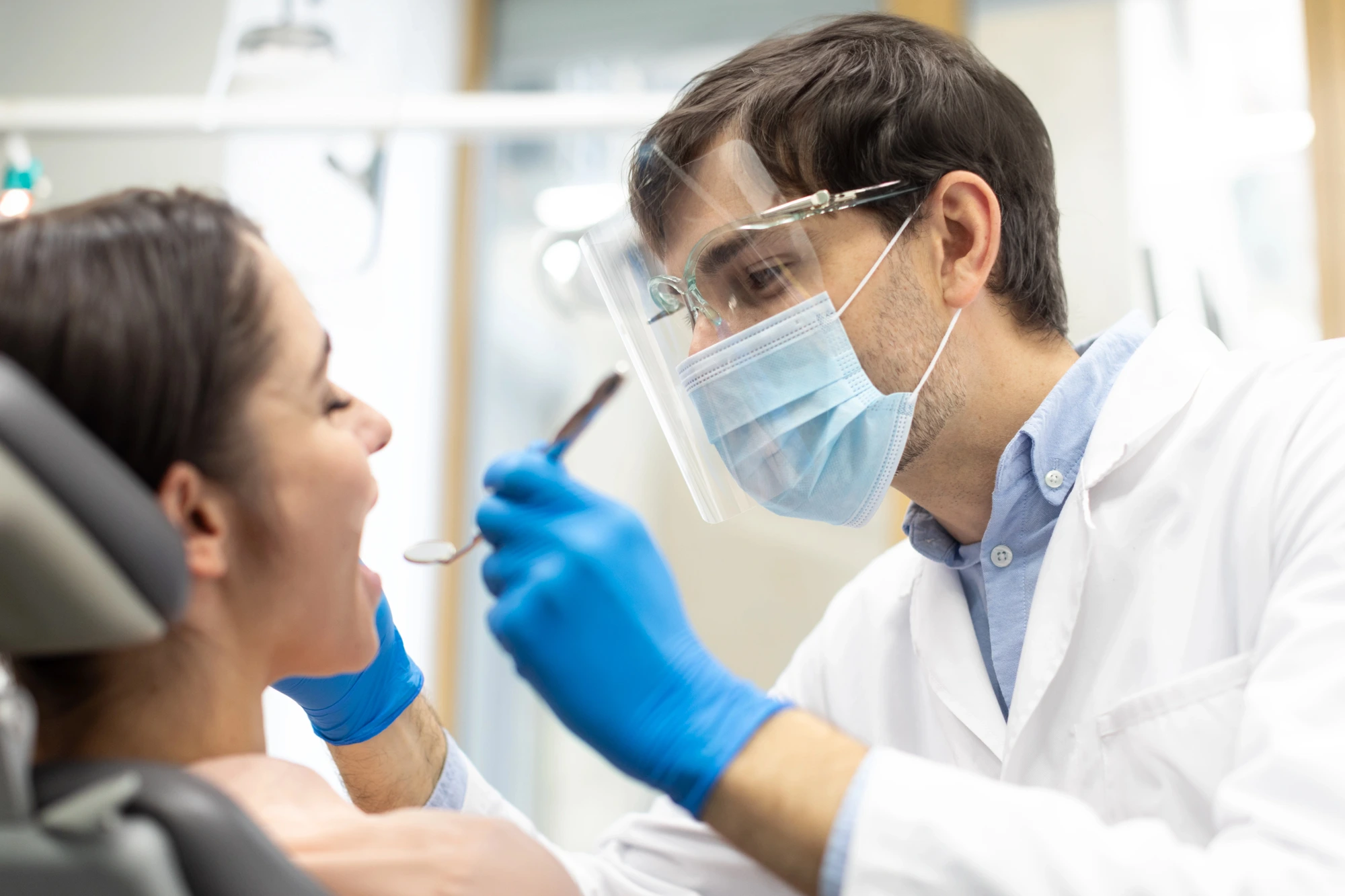 Orthodontist in Massapequa examining a patient before tooth extractions