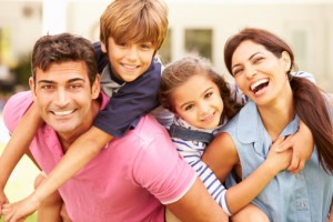 Happy family with beautiful smiles thanks to the family dentist massapequa residents prefer