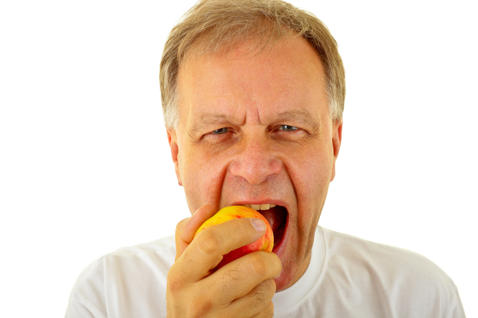 middle-aged man eating apple