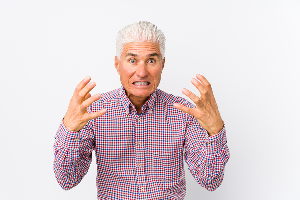 older man frustrated by lower denture